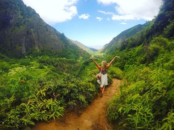 Rear view of woman standing on mountain