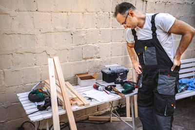 Rear view of man working at table