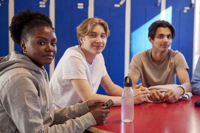 Teenagers sitting in locker room