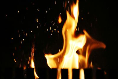 Close-up of fire against sky at night