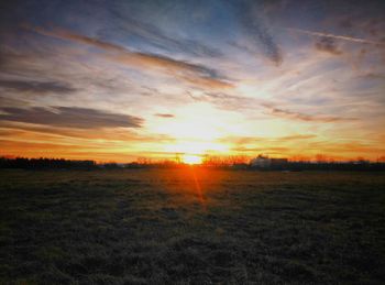 Scenic view of field against sky during sunset