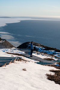 Man on a snowy walkway of hiking trail