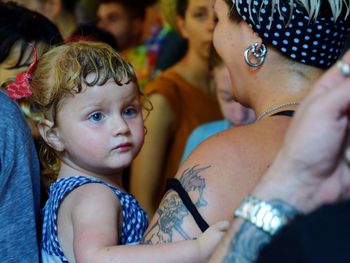 Portrait of mother and girl looking at friends