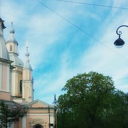 Low angle view of building against cloudy sky