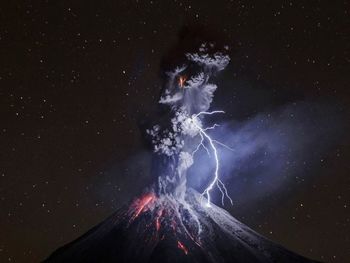 Low angle view of fireworks against sky at night