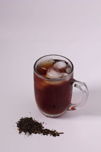 Close-up of coffee on table against white background