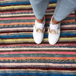 Low section of person standing on carpet