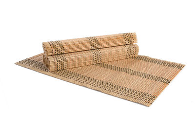 High angle view of bamboo place mats on white background