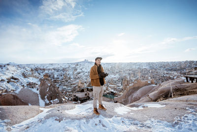 Portrait of woman standing on snow