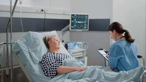 Female doctor examining patient in hospital