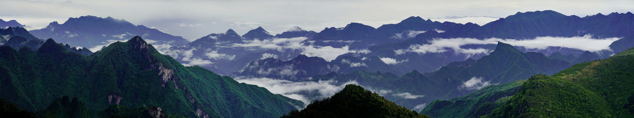 Panoramic view of mountains against cloudy sky