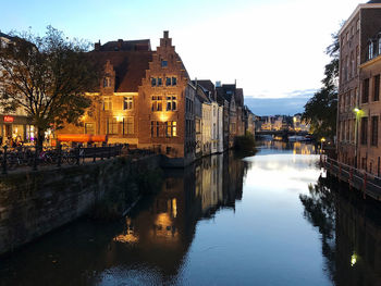 Canal amidst buildings against sky in city