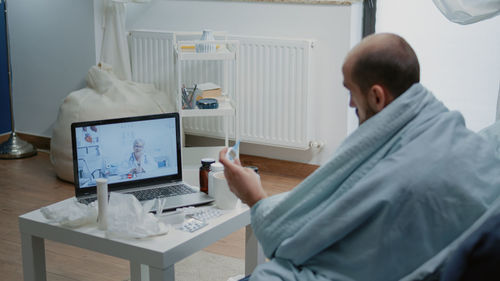 Man consulting with doctor on video call