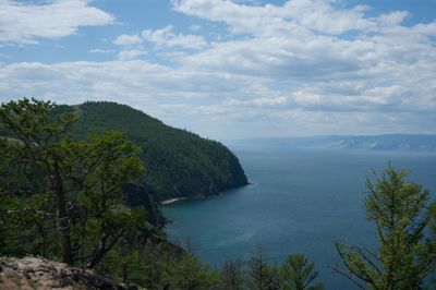 Scenic view of sea and mountains against sky