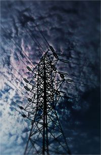 Low angle view of silhouette electricity pylon against sky