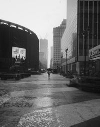 Man walking on road in city