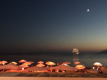 Scenic view of beach against clear sky at night