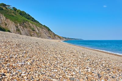 Scenic view of sea against clear blue sky