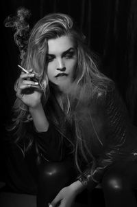 Beautiful young woman in cigarette