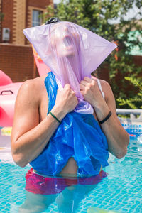 High angle view of woman sitting in swimming pool