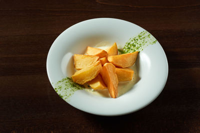 High angle view of fruits in plate on table