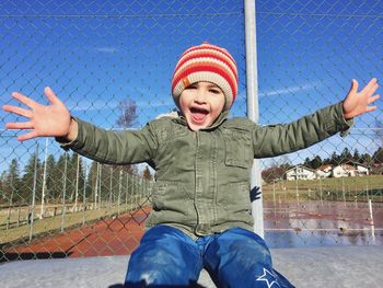 Boy playing with umbrella in winter