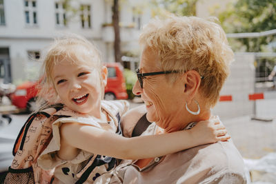 Happy girl enjoying with grandmother on sunny day