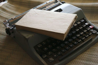 Close-up of book and typewriter on table