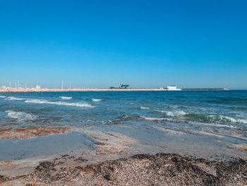 Scenic view of sea against clear blue sky