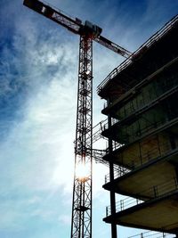 Low angle view of crane against sky