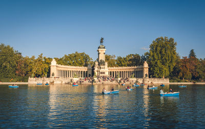 View of building in lake against blue sky