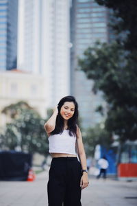 Portrait of woman standing in city