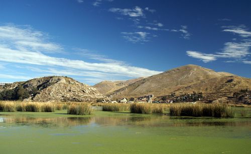 Scenic view of lake and mountains against sky