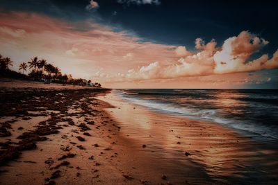 Scenic view of beach against sky during sunset