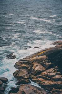 High angle view of rocks on sea shore