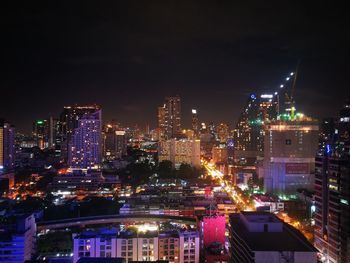 Illuminated cityscape against sky at night