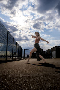 Full length of woman dancing on road