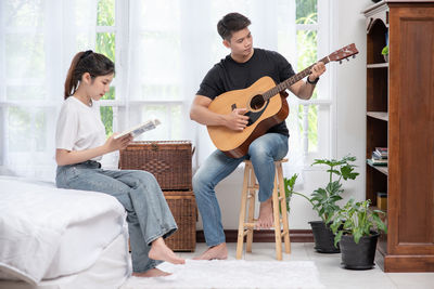 Full length of man playing guitar