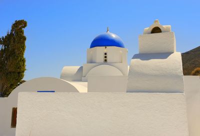 Low angle view of bell tower against blue sky