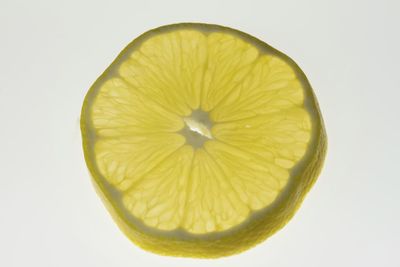 Close-up of lemon slice against white background