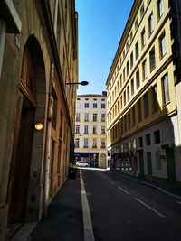 Street amidst buildings against sky in city