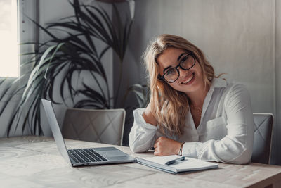 Young woman using laptop at home