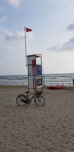 Lifeguard hut on beach against sky