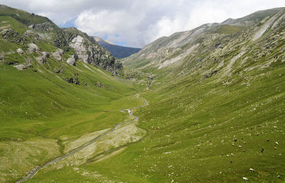 Scenic view of mountains against cloudy sky