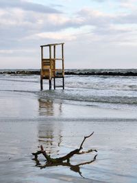 Lifeguard hut on beach against sky