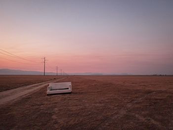 Scenic view of field against clear sky during sunset