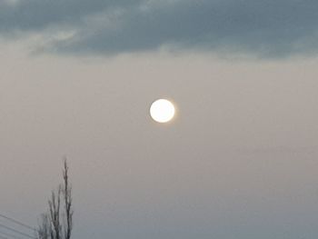 Low angle view of moon against sky during winter