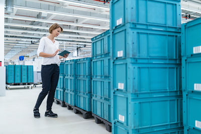 Businesswoman with tablet in a factory hall