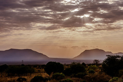 Scenic view of silhouette mountains against sky at sunset