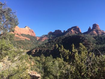 View of rock formation against clear blue sky